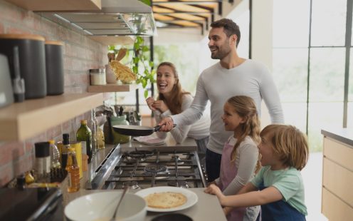 Family preparing food in kitchen at home
